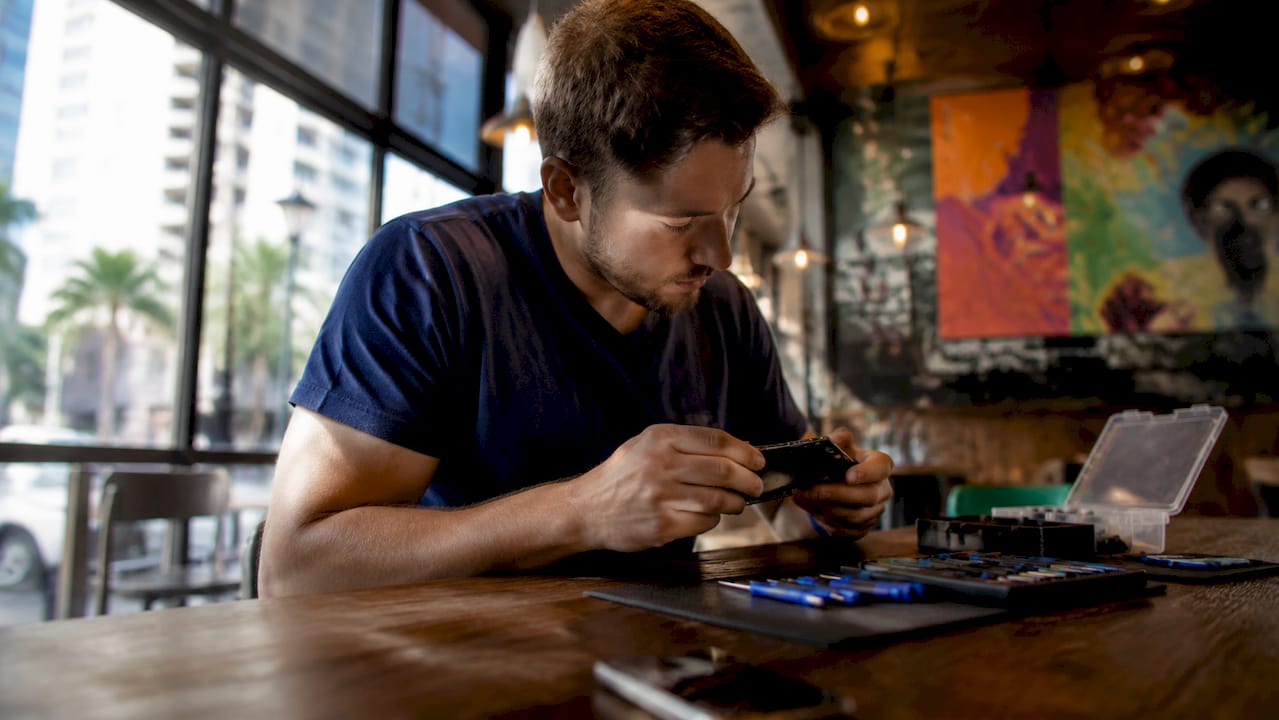 Technician inspecting smartphone for repair
