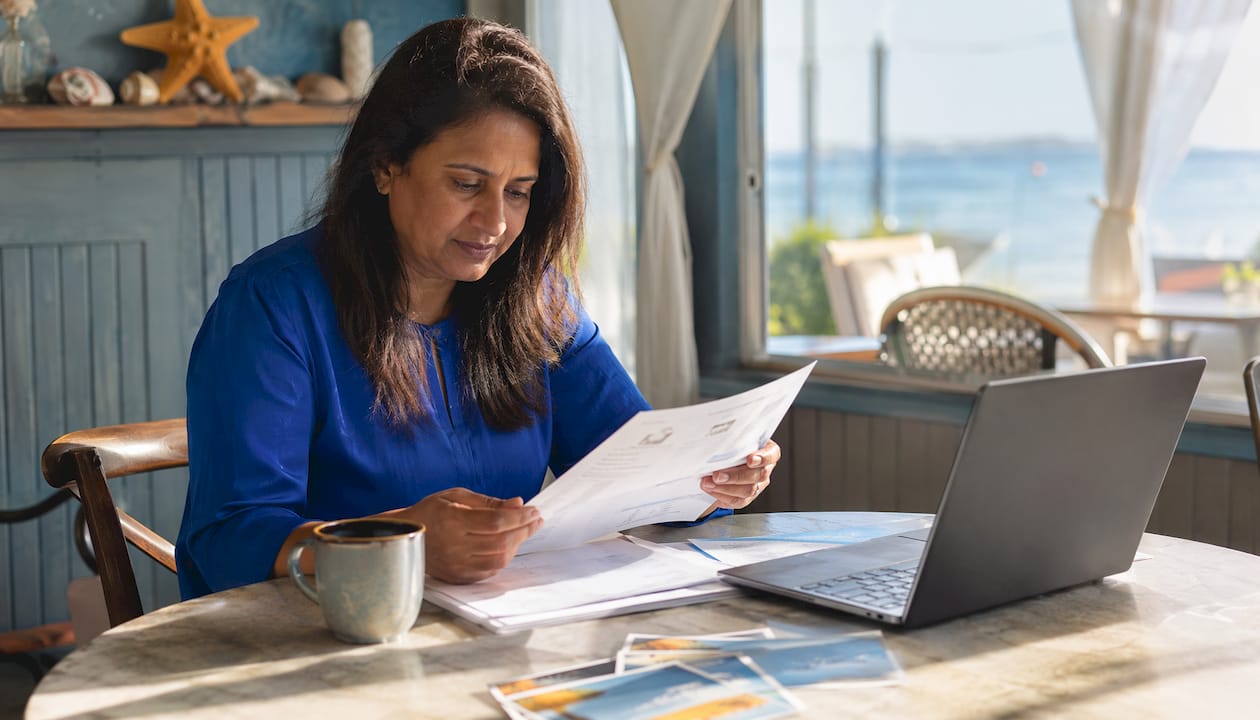 Woman reviewing phone technician documents