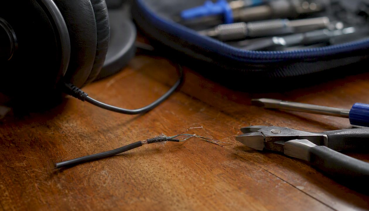 Frayed headphone cable with repair tools