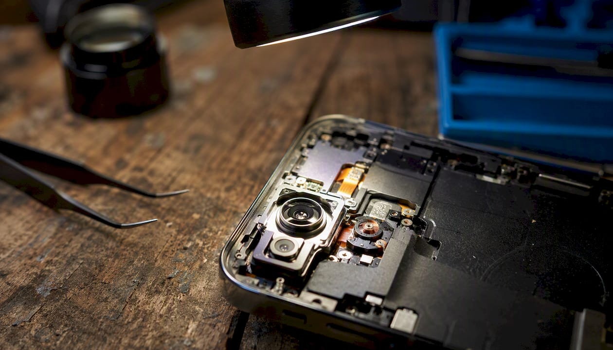 Close-up of phone camera module under repair