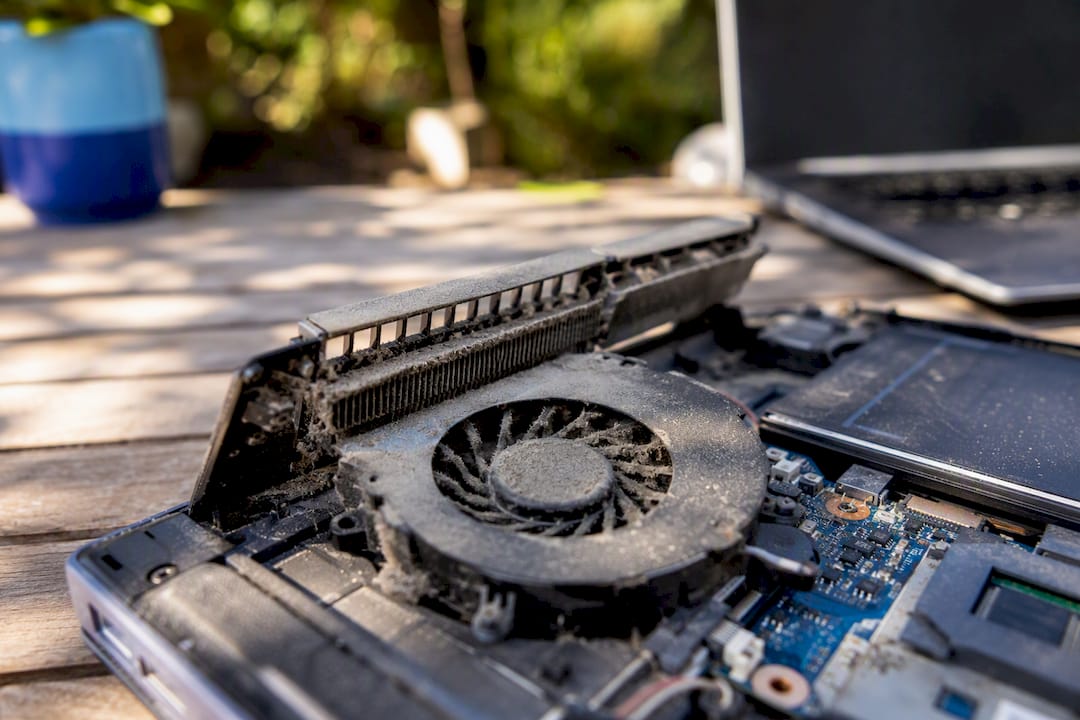 Dust-covered laptop cooling fan close-up