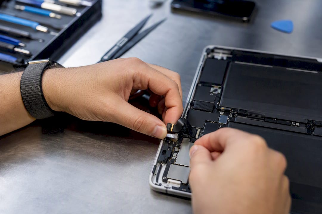 Technician handling tablet internal connector cable