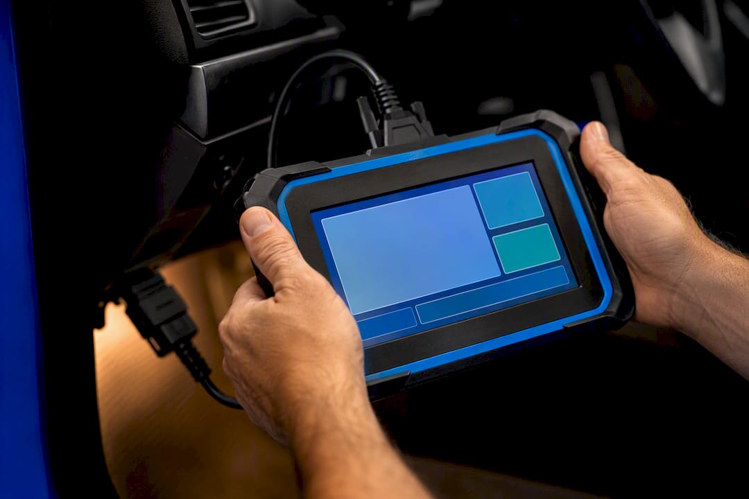 Technician using an automotive diagnostic scan tool