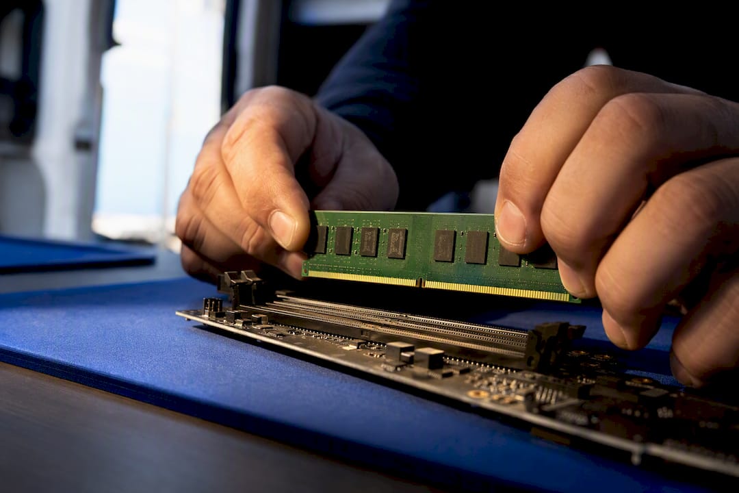 Technician checking RAM and motherboard compatibility