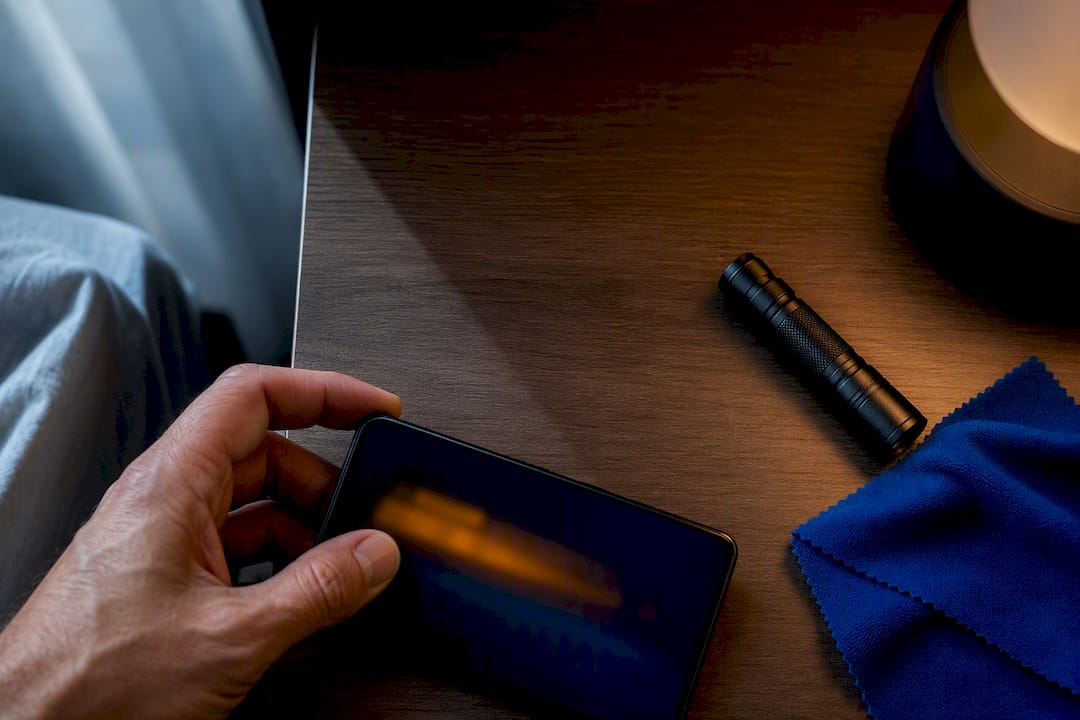 Hand inspecting an anonymous phone for spyware