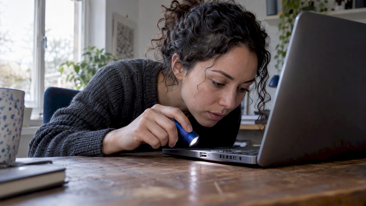 Careful flashlight inspection of a laptop USB port