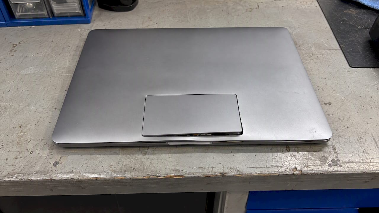Powered-off laptop with a lifted trackpad