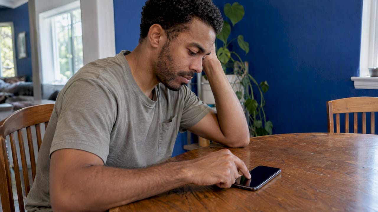 Man testing an unresponsive iPhone at home